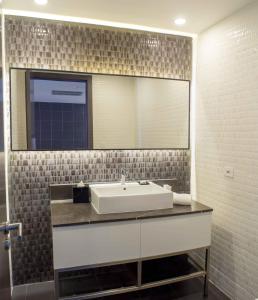 a bathroom with a sink and a large mirror at Sortis Hotel, Spa & Casino, Autograph Collection in Panama City