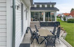 a deck with a table and chairs on a house at Stunning Home In Tors With Wi-fi in Vilsten