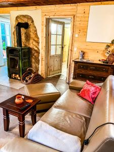 a living room with a couch and a wood stove at LIETHE 13 - Ferienhaus am Malerweg in Kurort Gohrisch