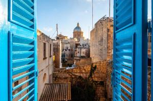 a view of a city from an open window at Kalkara Cozy 2 Bedroom Maisonette in Kalkara