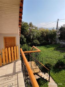 a balcony with wooden benches on a house at Σοφίτα Μαρτά in Kalamos