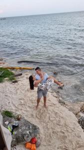 a man and a woman standing on the beach at Villa on The Beach Seaside Sunrise Haven 7 bedroom in Cancún