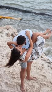 a man and a woman standing on the beach at Villa on The Beach Seaside Sunrise Haven 7 bedroom in Cancún