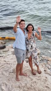 a man and a woman standing on the beach at Villa on The Beach Seaside Sunrise Haven 7 bedroom in Cancún