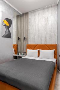 a bedroom with a large bed and a wall at InshiApartments on Vahylevycha Str in Lviv
