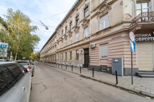 an empty street in front of a building at InshiApartments on Vahylevycha Str in Lviv