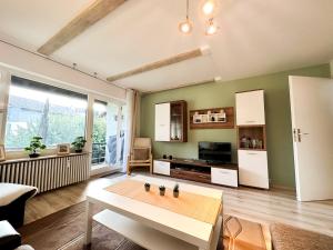 a living room with a table and a couch at Gipfelsicht in Oberstaufen