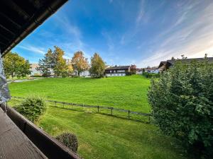 a view of a large green field with a house at Gipfelsicht in Oberstaufen