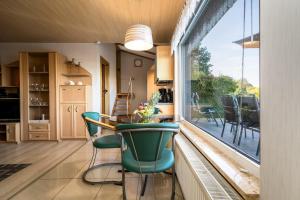 a kitchen with a table and chairs and a large window at Ferienhaus Haus am See mit Wassergrundstück in Lärz