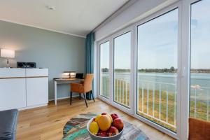 a room with a table with a bowl of fruit on a table at Ferienhaus Nordlicht Olpenitz in Olpenitz