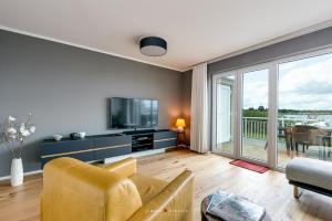 a living room with a couch and a tv at Ferienhaus Nordlicht Olpenitz in Olpenitz
