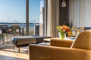 a living room with a view of the water at Ferienhaus Nordlicht Olpenitz in Olpenitz +24 photos