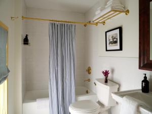 a bathroom with a white toilet and a shower at The Ell, a Historic, Luxurious 2 bed, 2 bath Private Suite in Lovell in Lovell