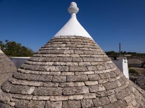 een stenen dak met daarop een kruis bij Villa with Trullo and Pool, Alberobello in Alberobello
