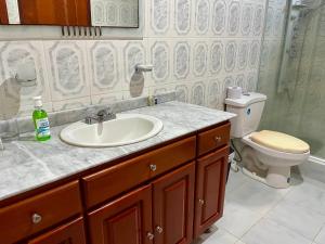 a bathroom with a sink and a toilet at HOSTAL MIRADOR TAYRONA in Santa Marta