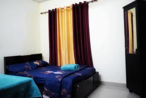 a bedroom with a bed and a window with curtains at chaithanya wellness centre in Vagamon
