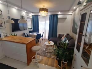 a living room and a kitchen with a table and a couch at Apartament Euro 2 Kraków in Krakow +29 photos