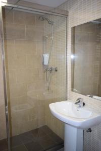 a bathroom with a sink and a shower at HOTEL VICTORIA in Arinsal