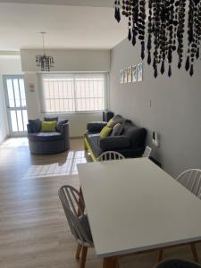 a living room with a table and a couch at Camino al Río in Viedma