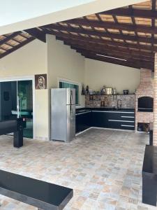 a kitchen with a stainless steel refrigerator in a room at Casa na praia in Itanhaém