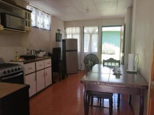 a kitchen with a refrigerator and a table in it at Casa Los Ángeles in Ángeles