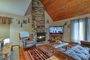 a living room with a fireplace and a tv at Smoky Mountain Getaway cabin in Cosby