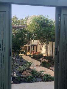 an open door to a house with a garden at סוויטה על שביל הים in Atlit