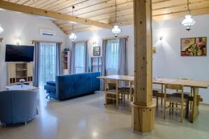 a living room with a table and a blue couch at Apartment Feher Lendava in Lendava