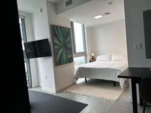 a white bedroom with a bed and a window at Downtown Miami Hotel in Miami