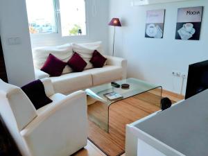a living room with a couch and a coffee table at Cozy Pool & Golf House at Condado de Alhama 