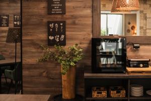 a restaurant with wooden walls and a vase of flowers at Interhotel Tatra in Kopřivnice