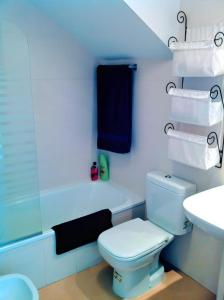 a bathroom with a white toilet and a sink at Cozy Pool & Golf House at Condado de Alhama 