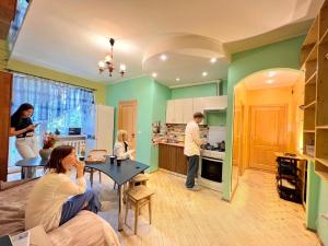 a group of people in a kitchen with a table at Pechersky Hostel in Kyiv