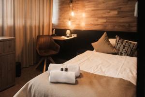 a hotel room with a bed with two towels on it at Interhotel Tatra in Kopřivnice