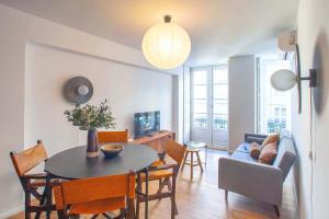 a living room with a table and a couch at Porto Downtown Flats in Porto