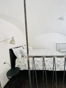 a bedroom with a bed with a table and a lamp at Loft10 in Putignano