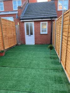 a garden with a lawn in front of a house at 1 Bedroom & Bathroom (No kitchen) (Garden) (Driveway) in Dorney