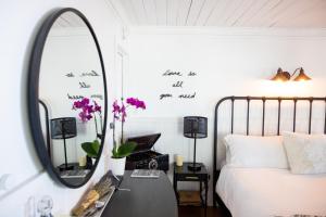 a bedroom with a bed and a mirror at 100 Mile View-Fire Pit, Romantic, Peaceful, Private in Crestline +59 photos