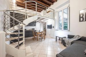 a spiral staircase in a living room with a kitchen at Duomo 10 minutes away - Loft with Wifi and Netflix in Milan