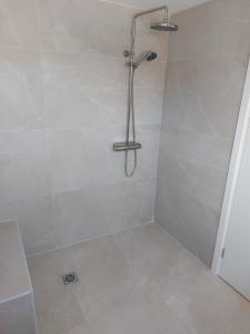 eine Dusche mit Duschkopf im Bad in der Unterkunft בריזה במדבר in Idan