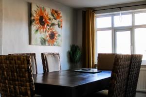 a dining room with a wooden table and chairs at The Brown Box Holiday Let in Loftus