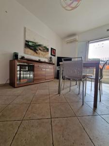 a living room with a table and chairs and a cabinet at A&M Home in Letojanni