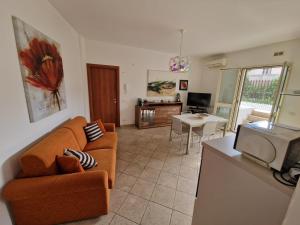 a living room with a couch and a table at A&M Home in Letojanni