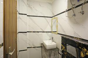 a bathroom with a sink and a mirror at Hotel De Clark Residency Delhi Airport in New Delhi