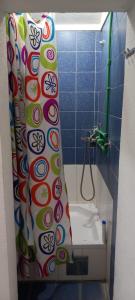 a bathroom with a shower curtain and a toilet at Vendela sobe in Banja Luka