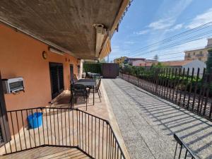 a patio with a table and chairs and a fence at A&M Home in Letojanni +5 photos