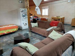 a living room with two couches and a refrigerator at REFUGIO La Pared in La Pared