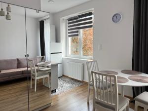 a kitchen and living room with a table and chairs at Apartament rodzinny 40m2 in Pabianice