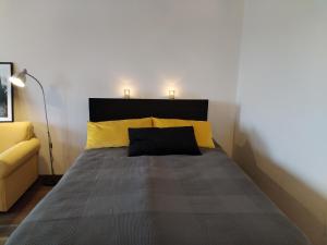a bedroom with a bed with two pillows at Viihtyisä yksiö Korialla in Kouvola