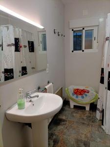 a white bathroom with a sink and a mirror at REFUGIO La Pared in La Pared